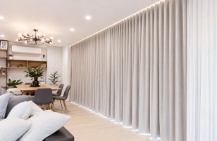 Modern full-length grey curtains in a bright contemporary living and dining room interior