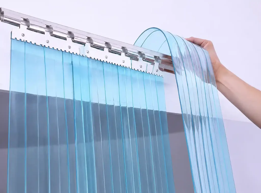 Transparent PVC curtain roll being installed.