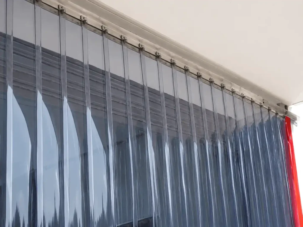 Transparent PVC strip curtain with stainless steel mounting system .