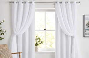 Soft white modern window curtains by Curtain Suppliers in Riyadh for elegant home interiors.