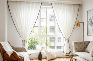 Minimal white sheer curtains in a bright modern living room.