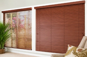 Modern wooden window blinds installed in a stylish living room interior with elegant sunlight control.