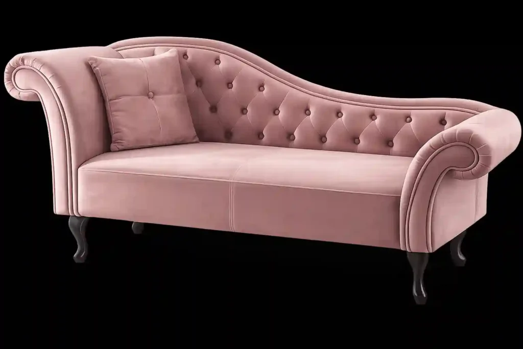 Pink Chesterfield couch with tufted backrest and curved arm design.