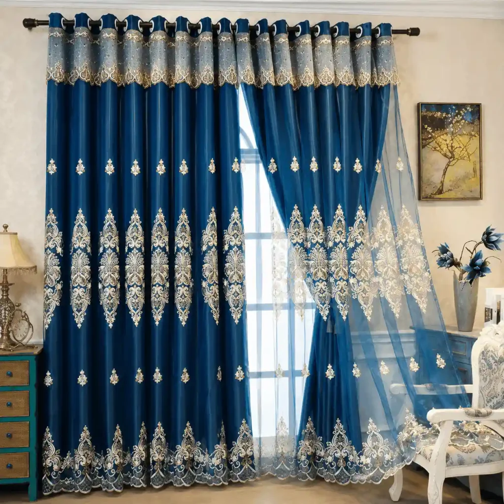 Royal blue sheer curtains with detailed embroidery and decorative lace borders.