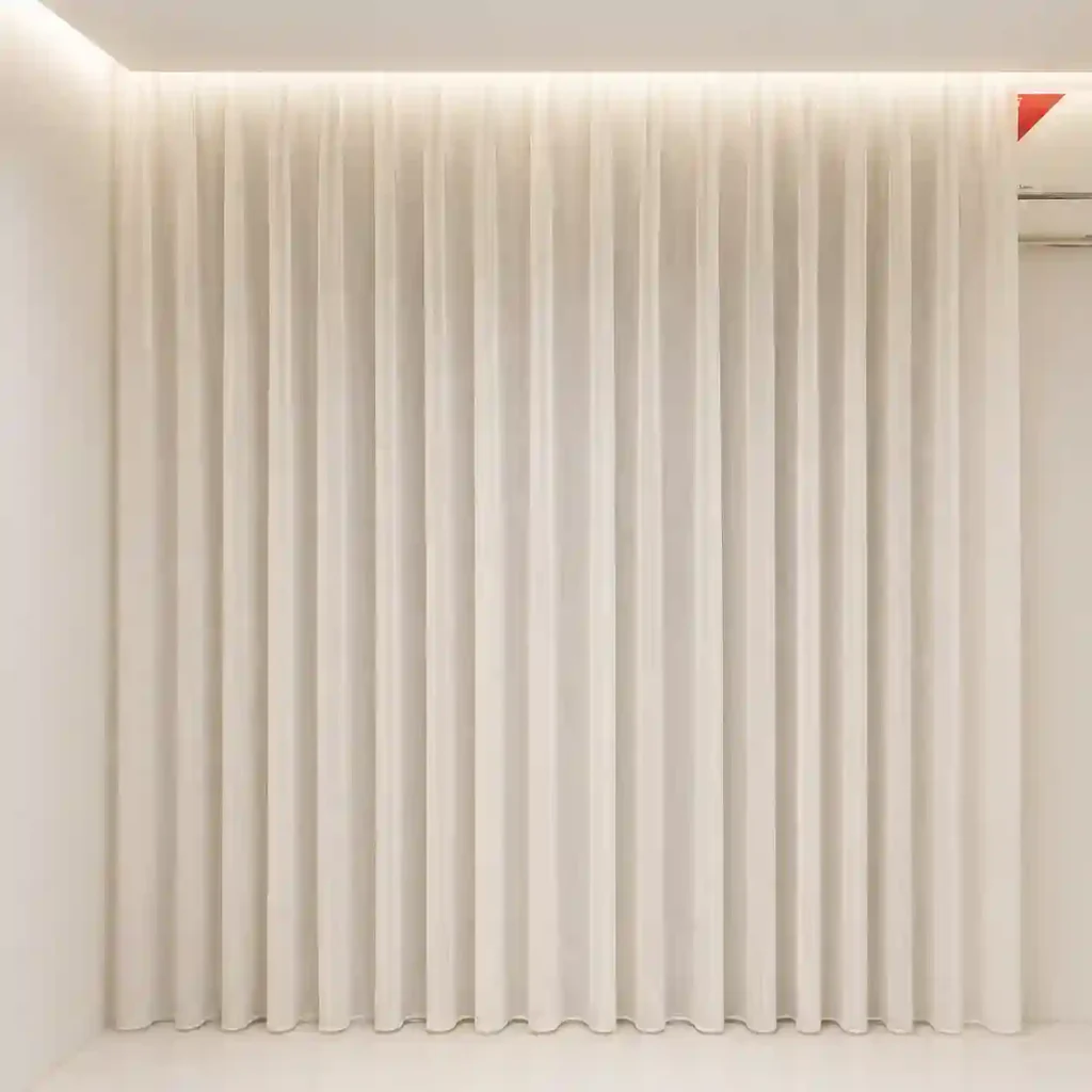 Cream blackout curtains in Riyadh with a clean vertical pleated look.
