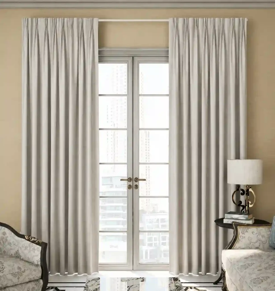 Elegant grey floor-length curtains installed around a glass French door.