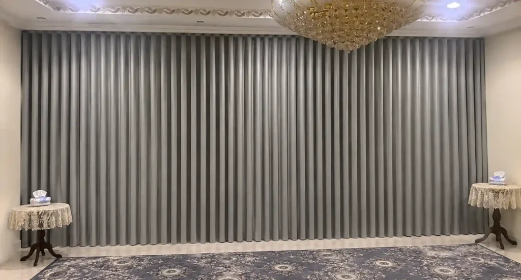 Grey hotel style curtains in a premium interior setting.