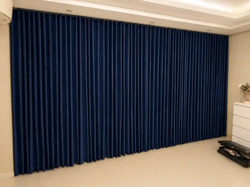 Navy curtain panels covering a full interior wall.